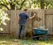 1774408024940_Homeowner-cleaning-wooden-backyard-fence