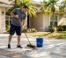 1775354644060_Homeowner-sweeping-sunlit-suburban-driveway