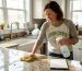 Homeowner scrubbing kitchen counter with microfiber