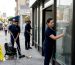 Cleaners working on a commercial storefront