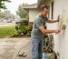 Homeowner restoring stucco wall curb appeal
