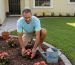 Homeowner planting flowers near tidy front door