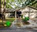 Homeowner cleaning walkway in summer Florida sunlight