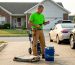 Homeowner checks pressure washer for driveway