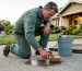 Technician cleaning fresh oil stain on driveway
