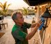 Homeowner cleaning outdoor light fixture