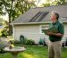 Homeowner inspecting roof black streaks