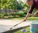 Homeowner applying sealant to clean driveway