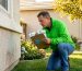 Home inspector examining exterior stucco