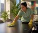 Commercial cleaner wiping conference table in office