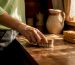 Hand cleaning wooden surface with soft bristle brush