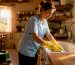 Professional cleaner wiping kitchen countertop