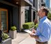 Property manager inspecting clean house exterior