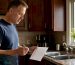 Property owner reviewing cleaning checklist indoors
