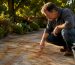 Homeowner inspecting rust stains on driveway