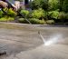 Pressure washer cleaning concrete driveway safely