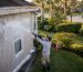 Technician soft washing house exterior