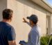 Homeowner inspecting professional exterior cleaning work